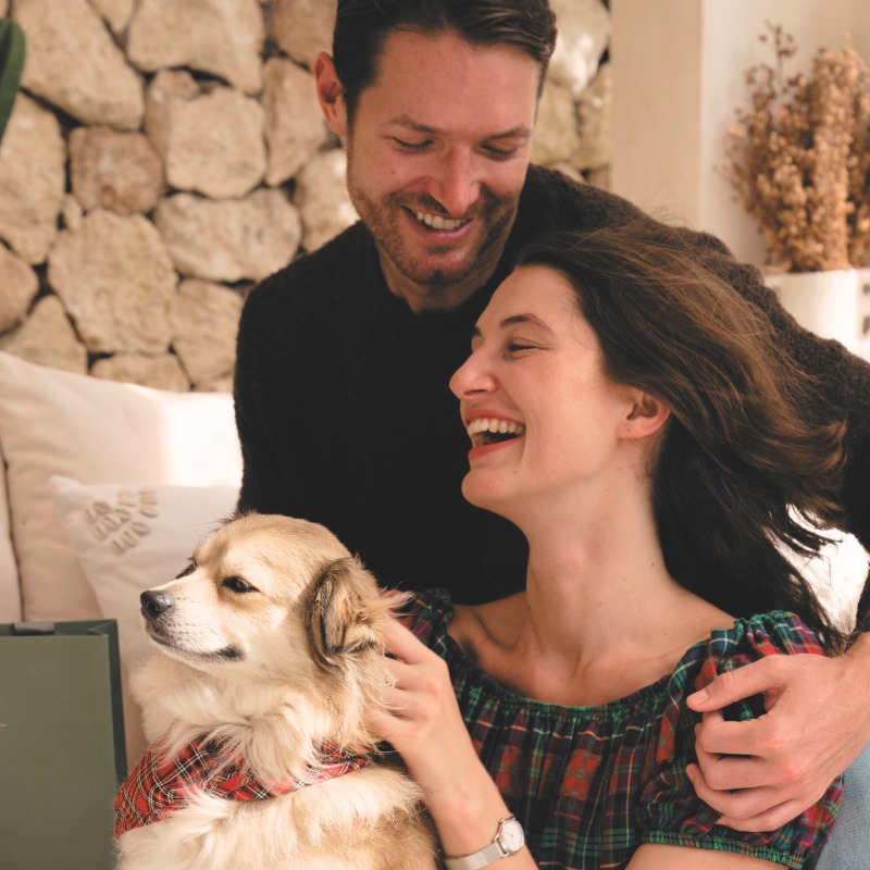 Couple laughing with their dog, wearing an August Berg watch